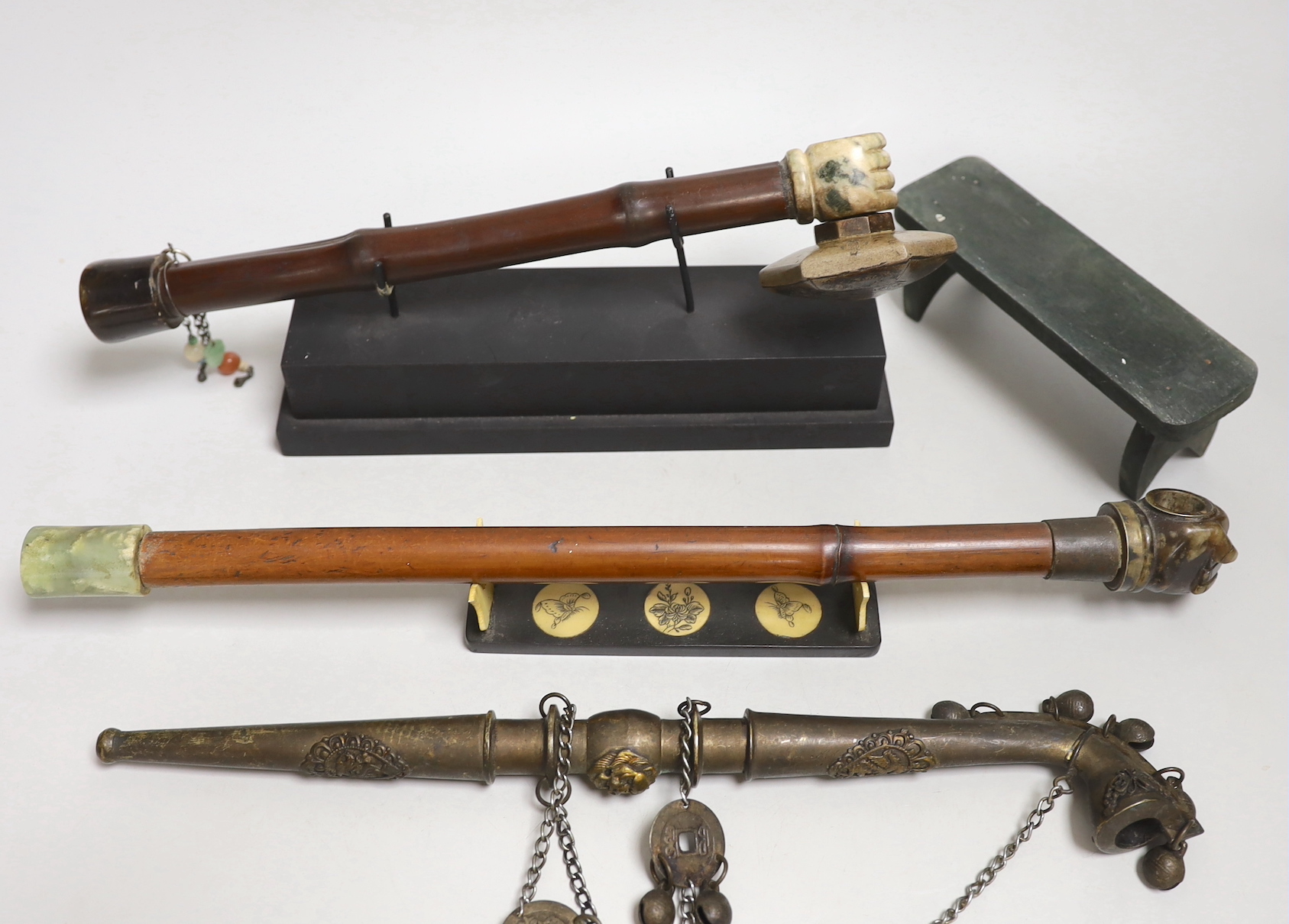 A collection of four Chinese or Indonesian opium pipes, 41.5cm long